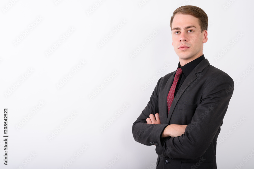 Young handsome businessman wearing suit against white background Young handsome businessman wearing suit against white background