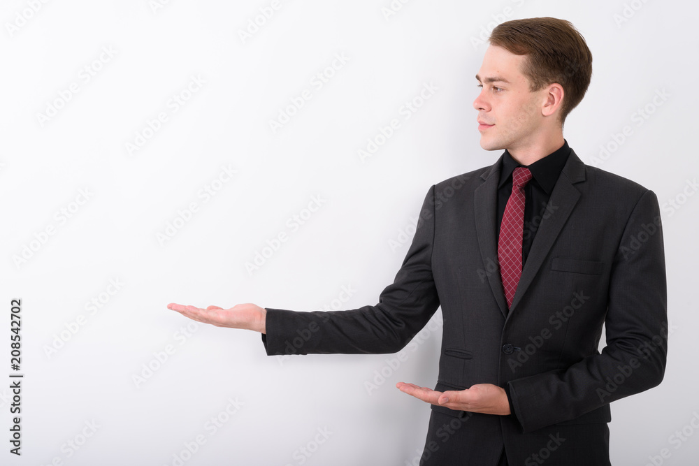 Young handsome businessman wearing suit against white background Young handsome businessman wearing suit against white background