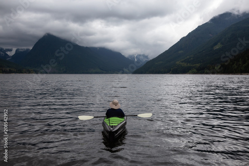 Adventurous Man on a Kayak is enjoying the beautiful Canadian Mountain Landscape. Taken in Jones Lake  near Chilliwack and Hope  East of Vancouver  BC  Canada.