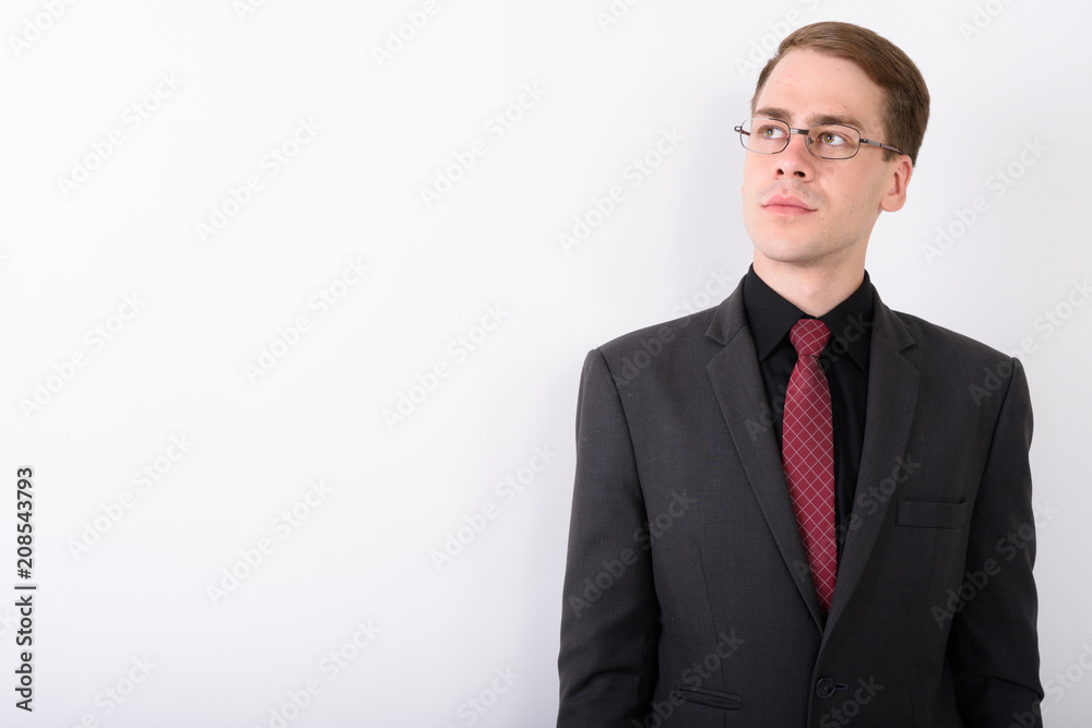 Young handsome businessman wearing suit against white background Young handsome businessman wearing suit against white background