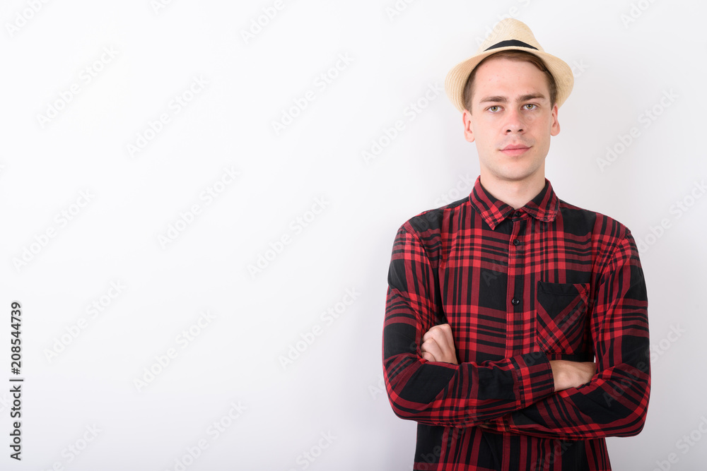 Young handsome tourist man wearing hat against white background Young handsome tourist man wearing hat against white background