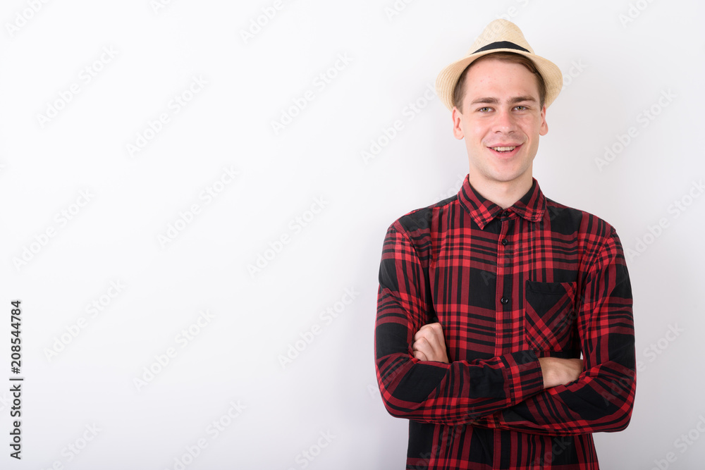 Young handsome tourist man wearing hat against white background Young handsome tourist man wearing hat against white background