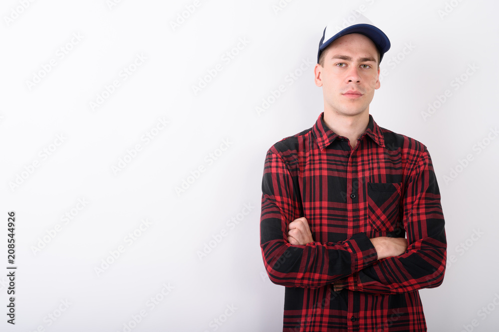 Young handsome man wearing baseball cap and red checkered shirt Young handsome man wearing baseball cap and red checkered shirt