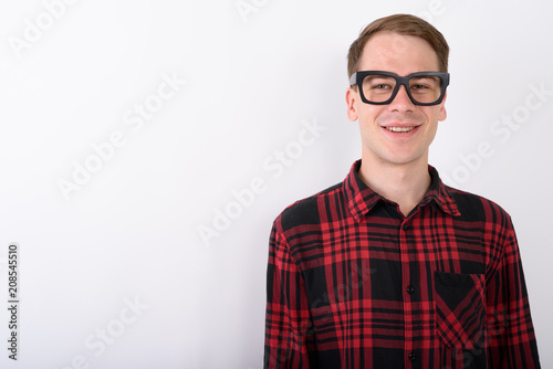 Young handsome man wearing eyeglasses against white background © Ranta Images