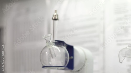 Laboratory interior. Jar with solution and machine for testing factory products. Glass flask spinning photo