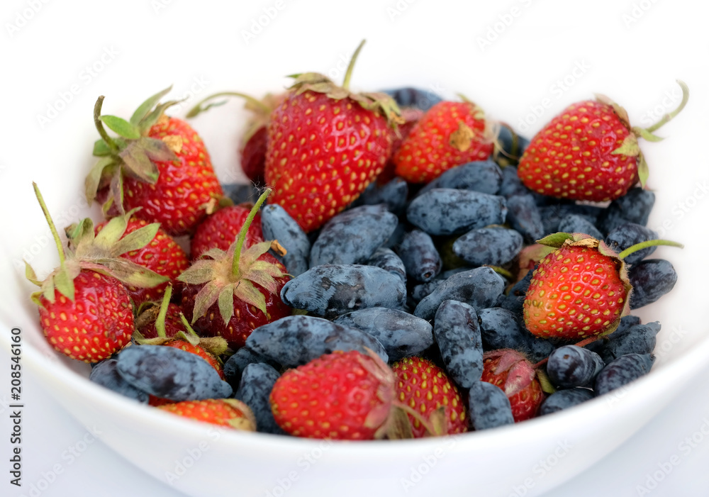 Still life, with fruit assorted platter with lot ripe appetizing strawberry and honeysuckle isolated ob white background studio shot front view closeup Still life, with fruit assorted platter with lot ripe appetizing strawberry and honeysuckle isolated ob white background studio shot front view closeup