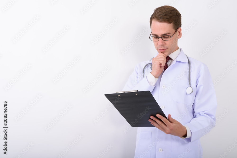 Young handsome man doctor wearing eyeglasses against white backg Young handsome man doctor wearing eyeglasses against white backg
