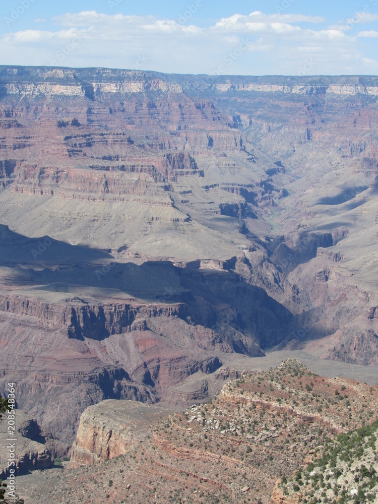 Views of the Grand Canyon with a large shadow from a cloud over it seen from the south rim in Arizona Views of the Grand Canyon with a large shadow from a cloud over it seen from the south rim in Arizona