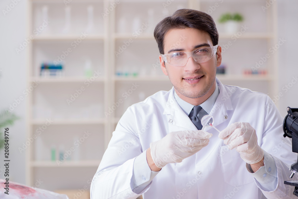Expert criminologist working in the lab for evidence Expert criminologist working in the lab for evidence
