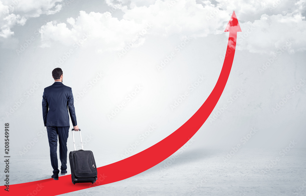 Young businessman with back leaving on the red arrow carpet to the skies with luggage on his hand
Young businessman with back leaving on the red arrow carpet to the skies with luggage on his hand