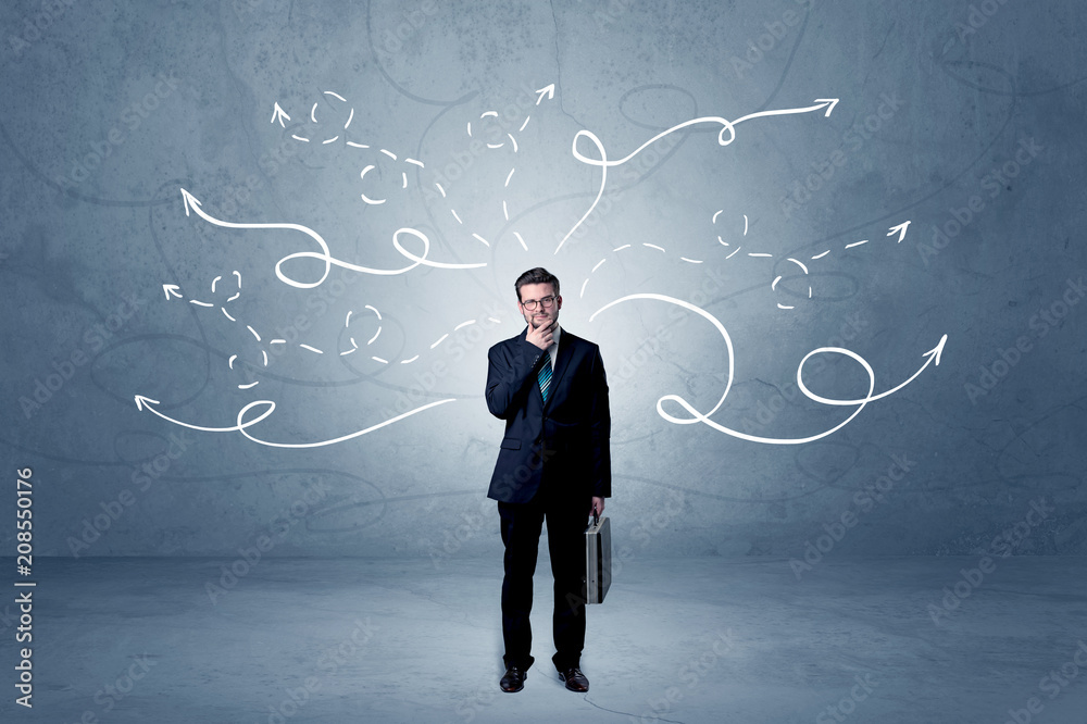 Elegant businessman choosing between directions with winding drawn arrows around
Elegant businessman choosing between directions with winding drawn arrows around