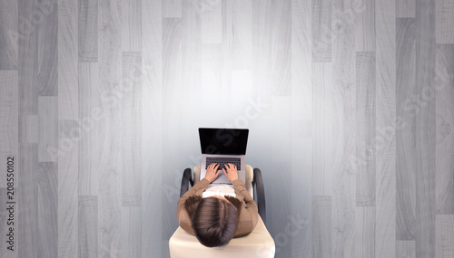 Empty office with woman in a chair and device on her hand 