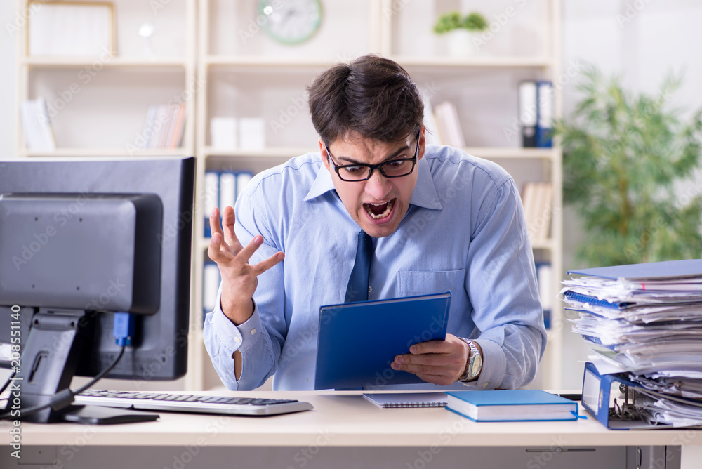 Tired businessman with too much paperwork Tired businessman with too much paperwork