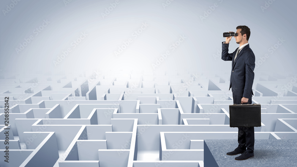 Businessman standing on maze and looking forward to the future concept
Businessman standing on maze and looking forward to the future concept