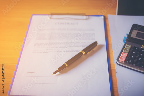 Mortgage contract for sale of real estate property with a pen and house keys