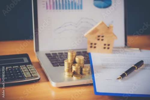 A scale house on some forms for a deed to conceptualize on the financial investment.