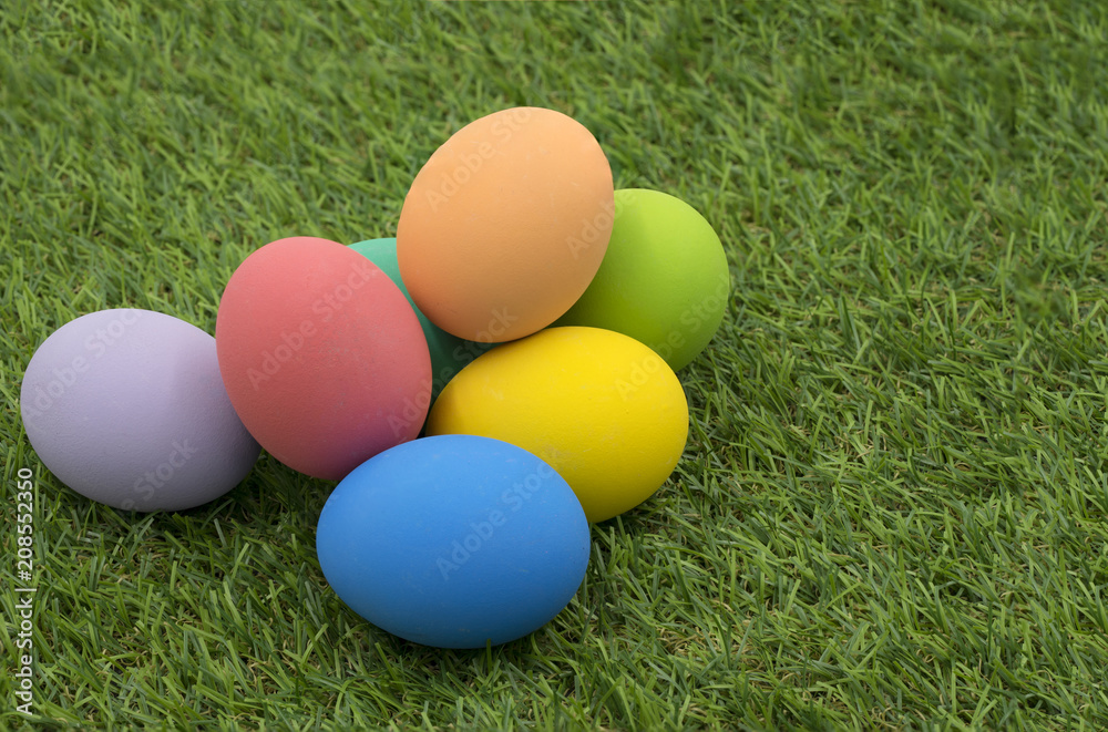 colorful easter eggs on green grass background colorful easter eggs on green grass background