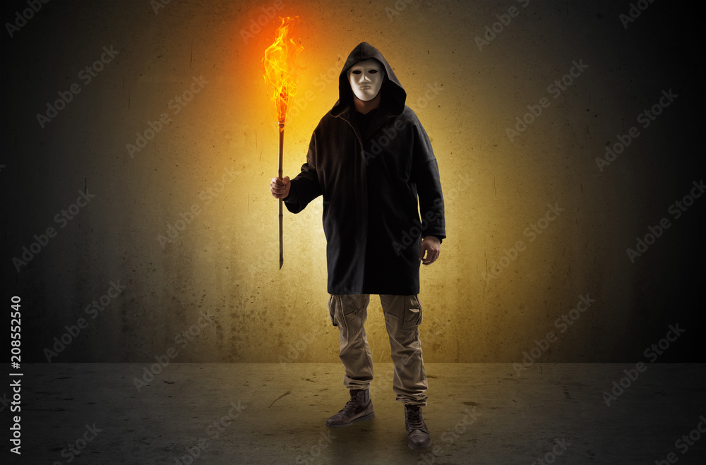 Ugly scary man with burning flambeau walking in an empty space Ugly scary man with burning flambeau walking in an empty space