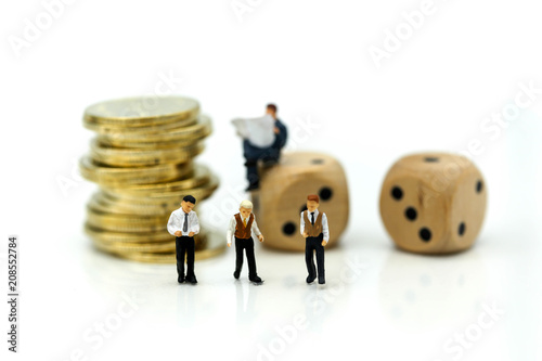 Miniature people businessman meeting with stack of coins and dices, risk of business concept.