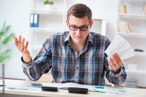 Young man frustrated at his house and tax bills