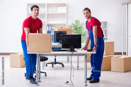 Two contractor employees moving personal belongings photo