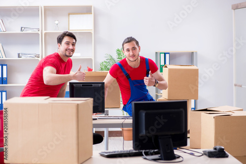 Two contractor employees moving personal belongings