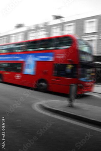 Iconic London red double decker bus, abstract with motion blur and selective color