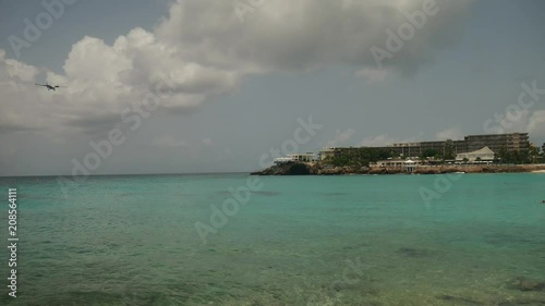 Airplane is overflowing sea shore of Maho Beach