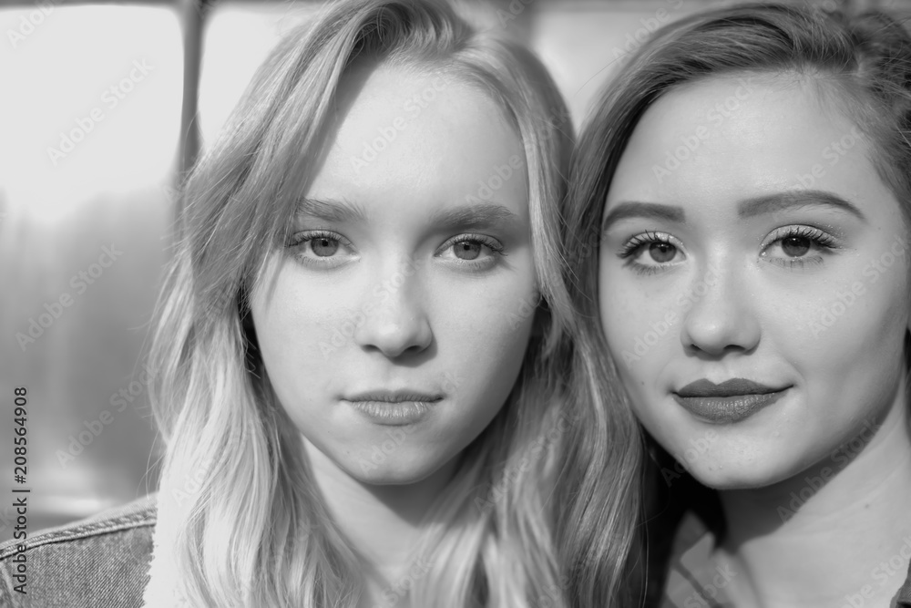 Beautiful best friends standing against urban building Beautiful best friends standing against urban building
