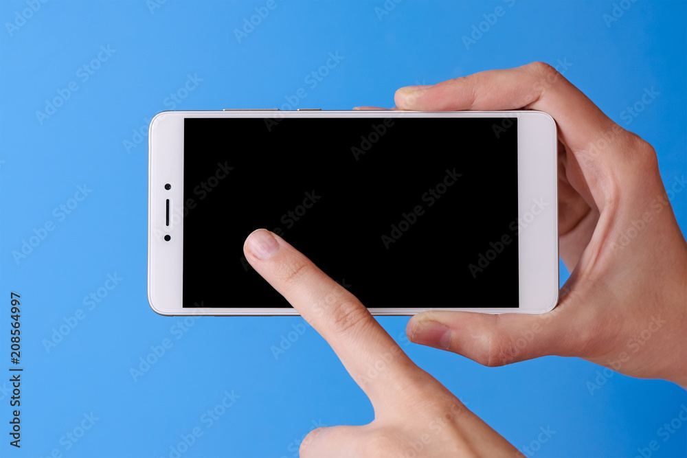 woman's finger touching on phone mobile with isolated display on blue background