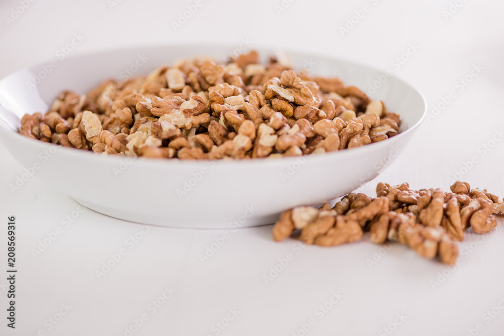 bowl of whole wallnuts on white background bowl of whole wallnuts on white background