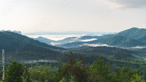Sunrise over misty or hazy forested mountains in Croatia