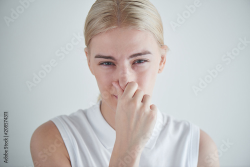 a girl is covering her nose