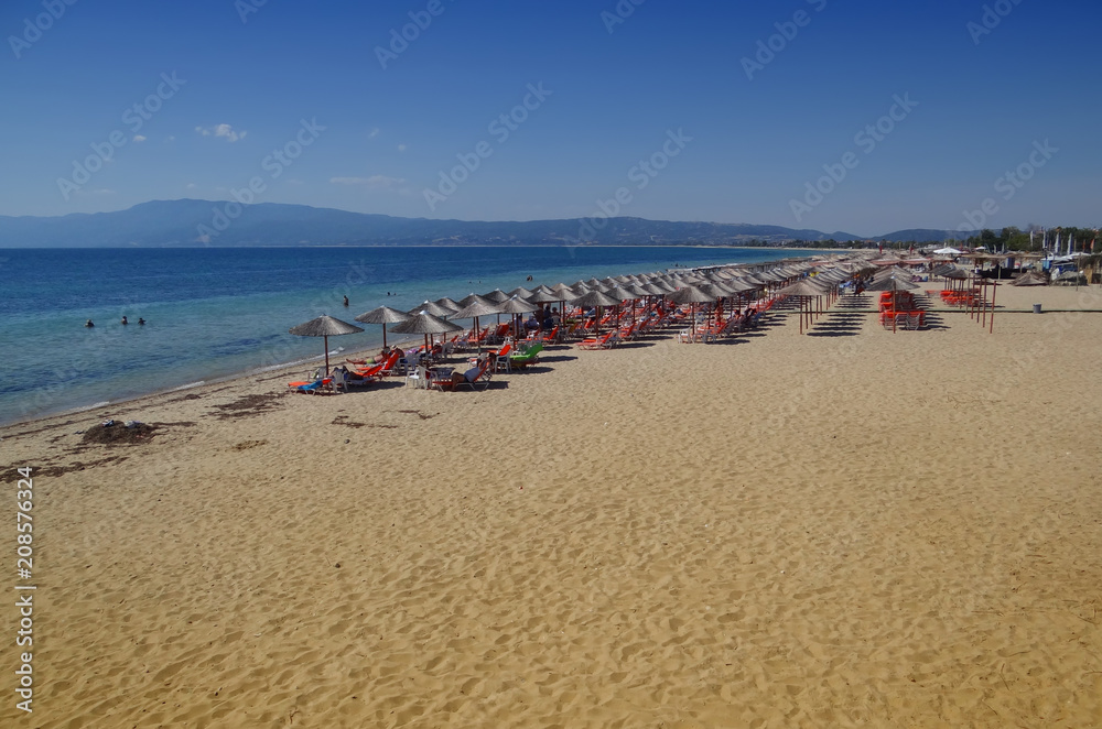Syunny beach with umbrellas and a clean blue sea
