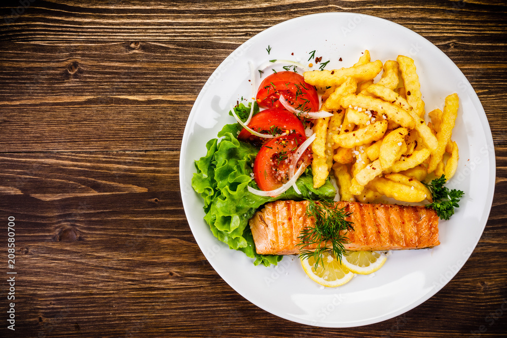 Fried salmon, chips and vegetables Fried salmon, chips and vegetables