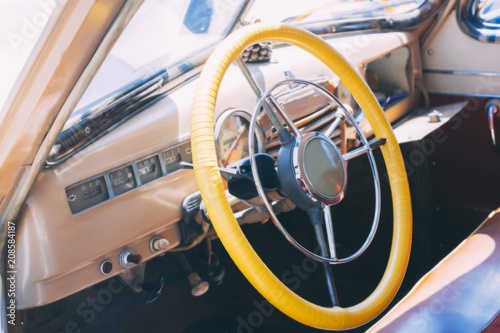 Dashboard retro antique car. Vintage steering wheel, speedometer