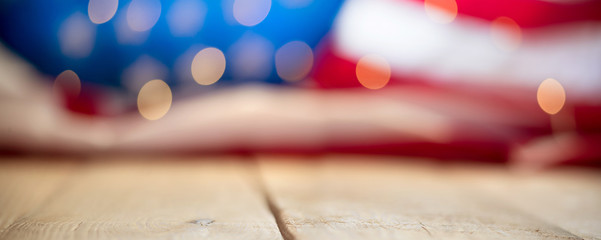 Flag of the USA with string lights on a wooden vintage table. 4th of July celebration concept