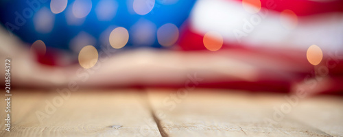 Flag of the USA with string lights on a wooden vintage table. 4th of July celebration concept