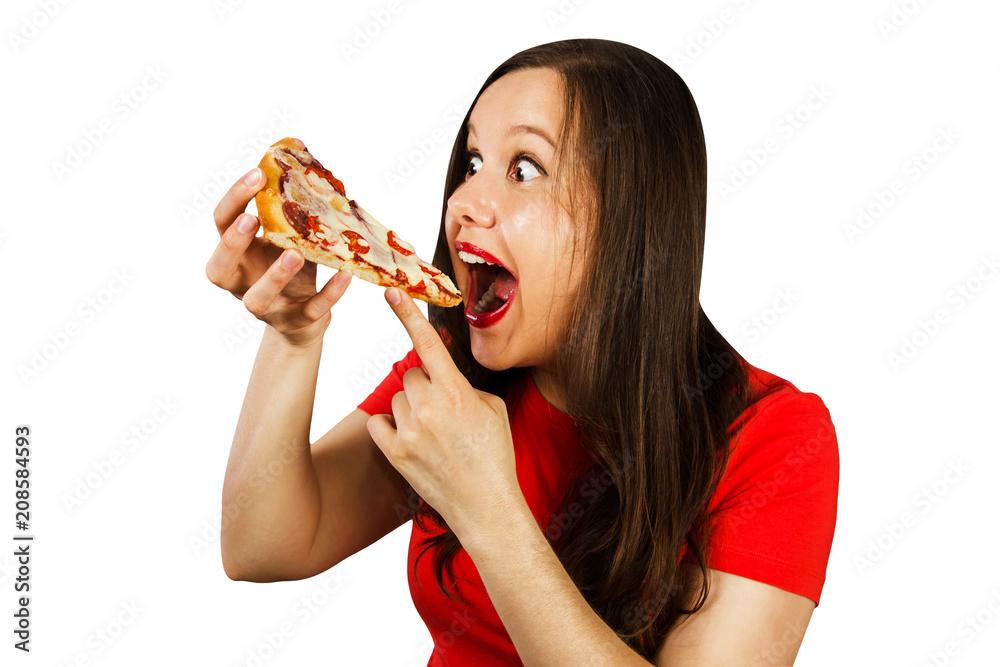 Young handsome girl greedily devouring pizza, isolated on white background. Side view. Young handsome girl greedily devouring pizza, isolated on white background. Side view.