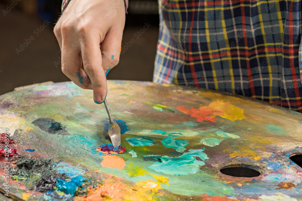 Art painting with palette knife. hand of the artist Art painting with palette knife. hand of the artist