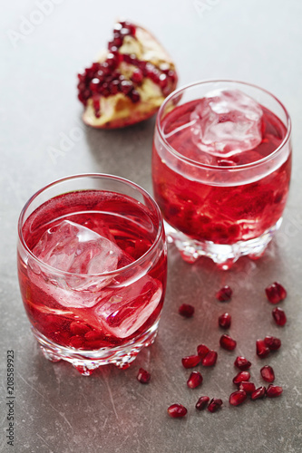 two glasses of red cocktails on gray background