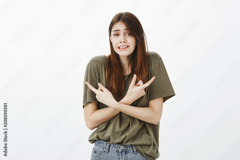 Girl worry boss will pick her, pointing at colleagues nervously. Insecure unconfident attractive female student, frowning and making intense expression, indicating at both directions anxiously Girl worry boss will pick her, pointing at colleagues nervously. Insecure unconfident attractive female student, frowning and making intense expression, indicating at both directions anxiously