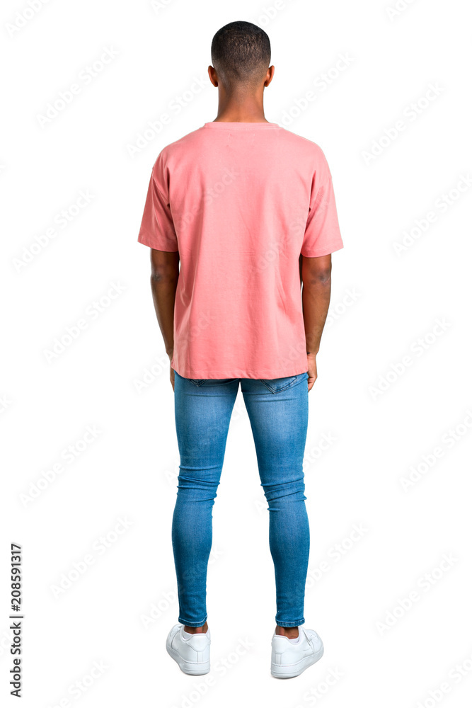 Standing young african american man looking back on isolated white background. Ideal for use in architectural designs