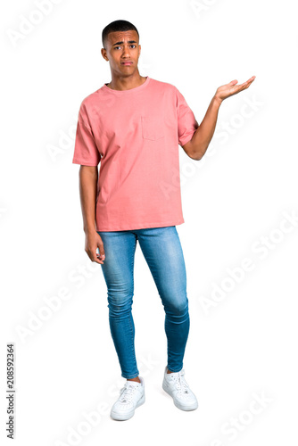 Standing young african american man unhappy and frustrated with something. Negative facial expression on isolated white background