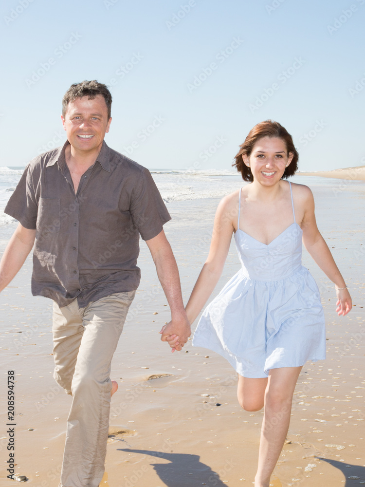 smile happy couple walking on sea beach in summer smile happy couple walking on sea beach in summer