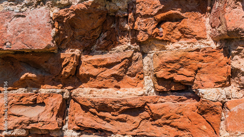 Destroyed  ancient  red brick wall of monastery. photo