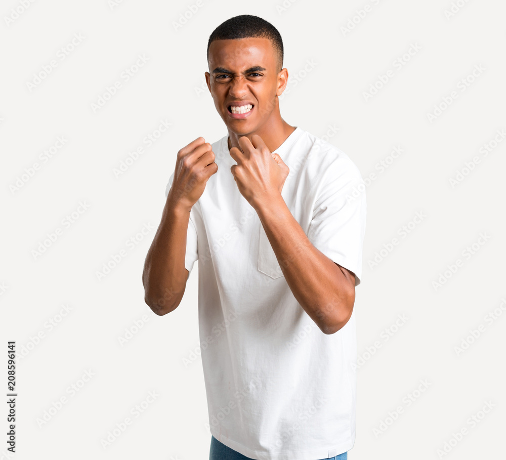 Young african american man annoyed angry in furious gesture. Frustrated by a bad situation on isolated background Young african american man annoyed angry in furious gesture. Frustrated by a bad situation on isolated background