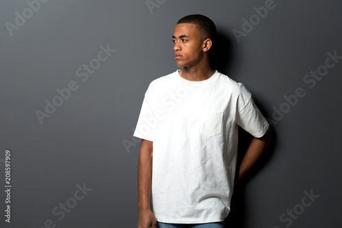 Young african american man on grey wall background