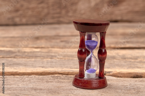 Stylish hourglass on wood background. Time management concept.
