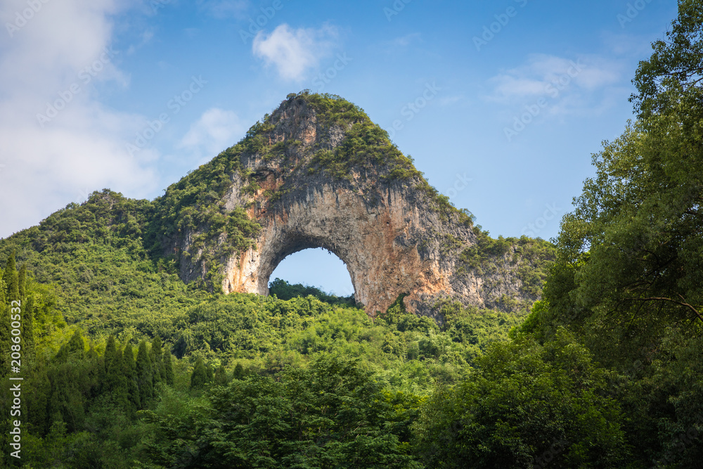 Fototapeta premium Scenic summer sunny landscape at Moon Hill, Yangshuo County of Guilin, China.